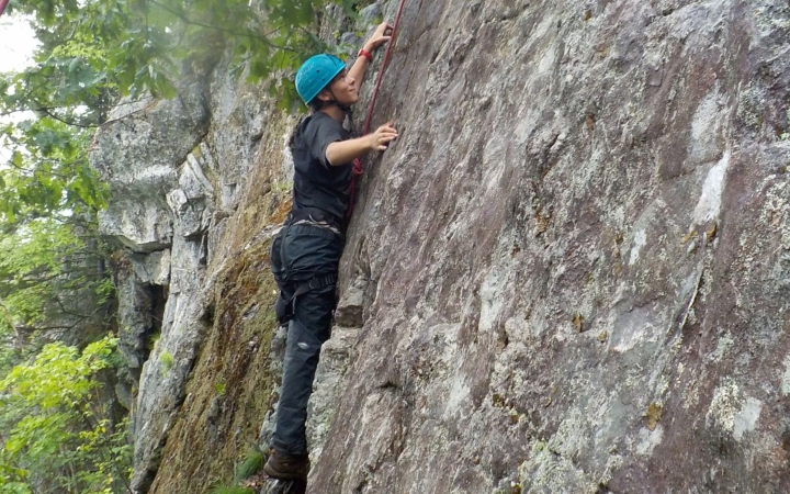 a rock climber navigates a rock wall